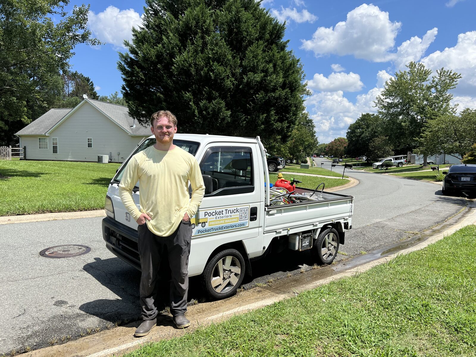 Carter, owner of Pocket Truck Exteriors, standing in front of the branded truck